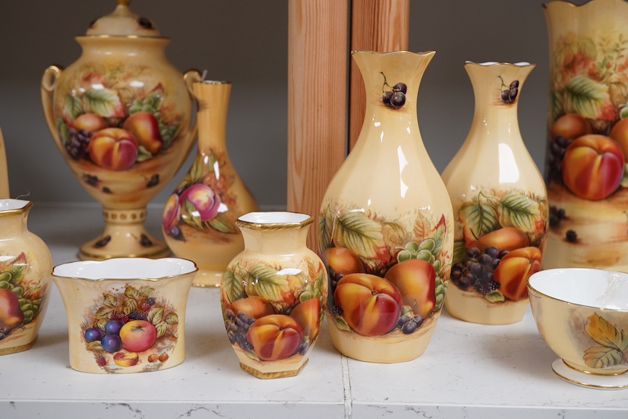 A collection of Aynsley Orchard Gold wares including a timepiece, vases, etc. tallest 23cm